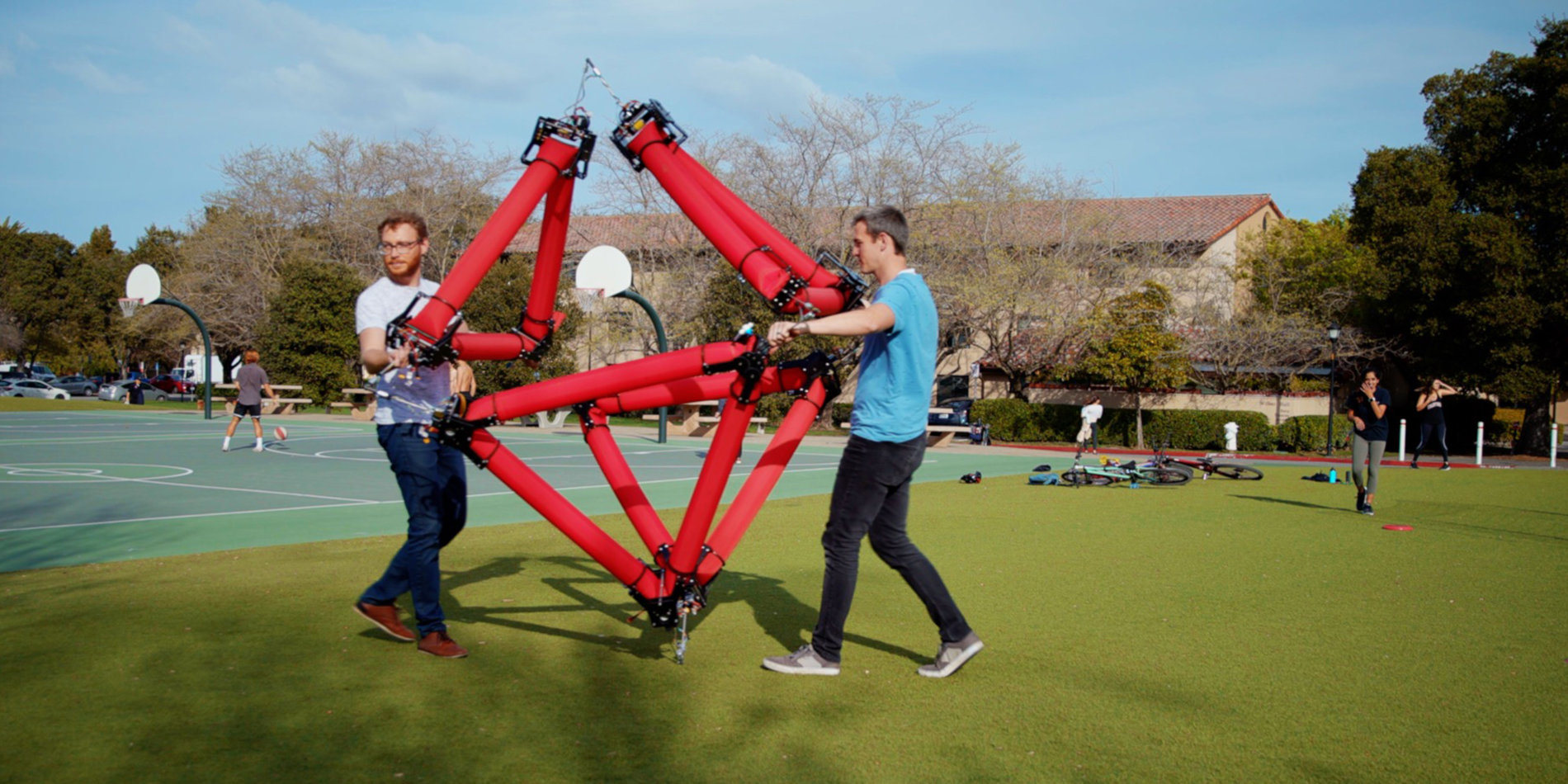 
Graduate students Zachary Hammond, left, and Nathan Usevitch with the isoperimetric robot | Photo by Farrin Abbot 