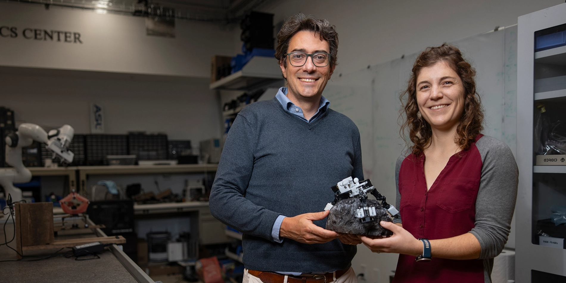 Associate Professor Marco Pavone and PhD student Stephanie Newdick holding their ReachBot prototype. 