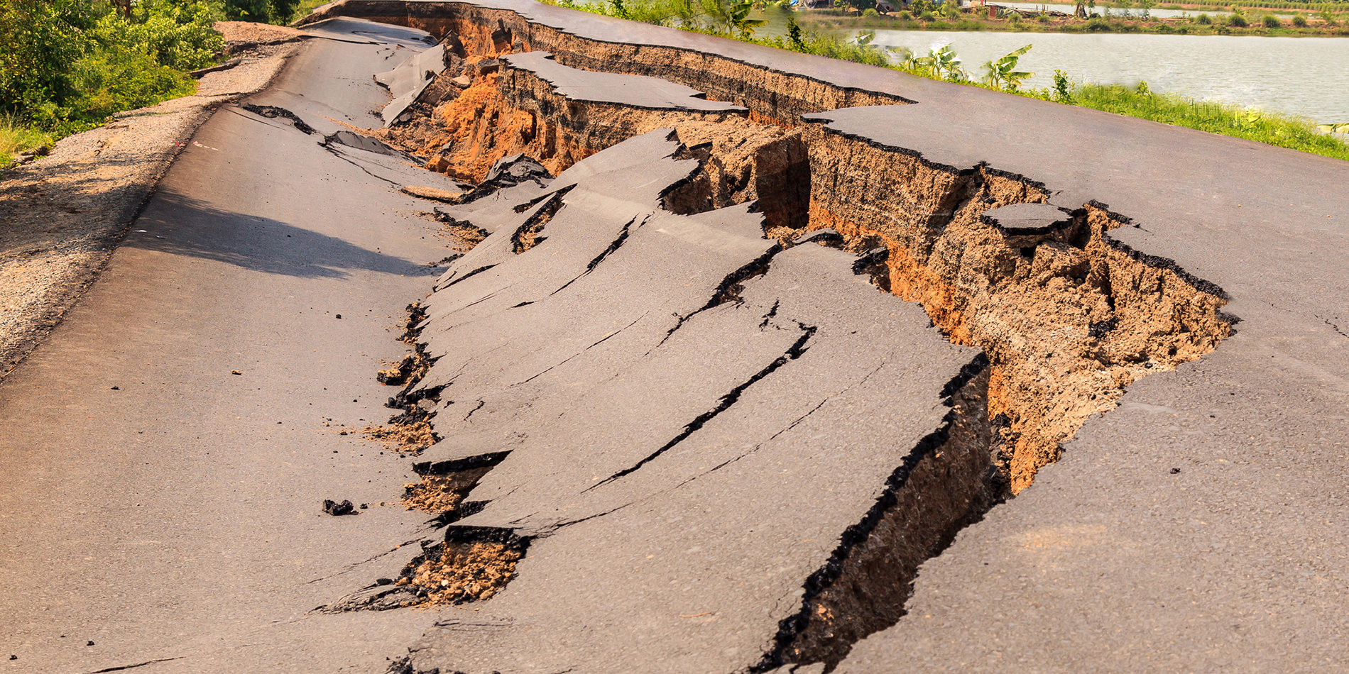 Photo of a cracked asphalt road after an earthquake.