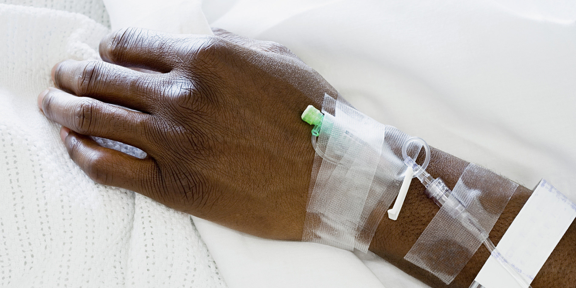 Photo of a patient's arm with IV drip. 