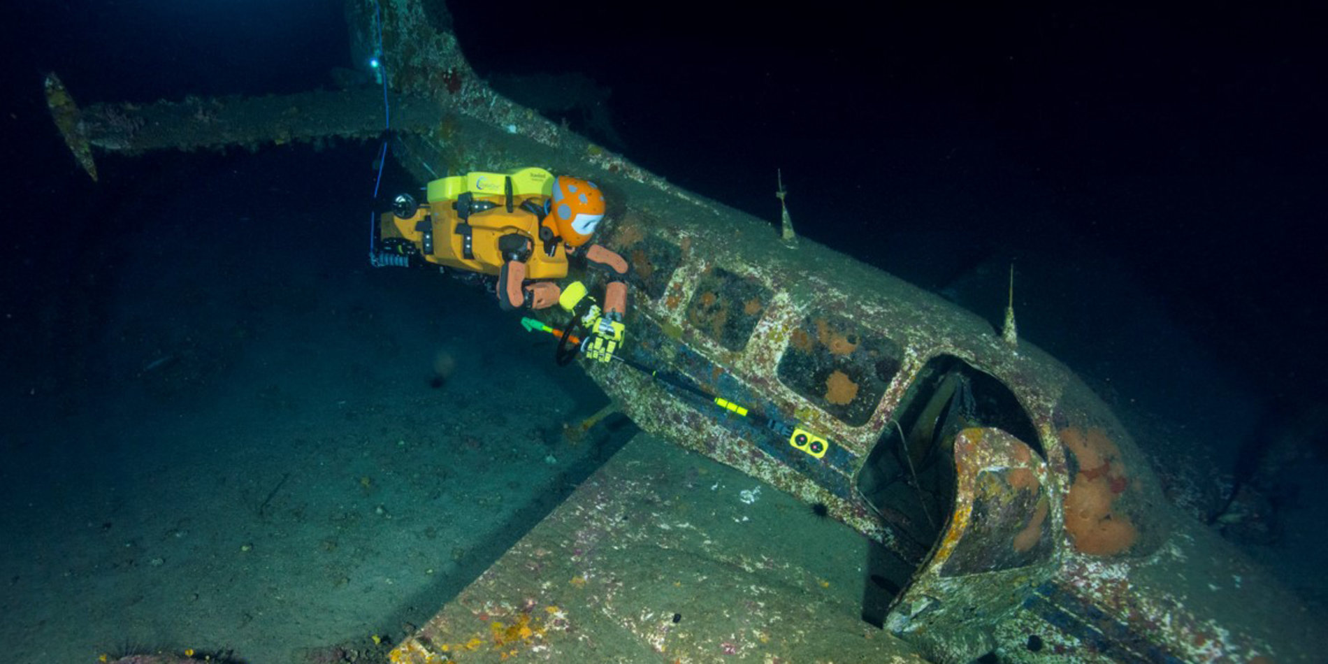 Photo of underwater robot OceanOneK exploring an underwater plane wreck.