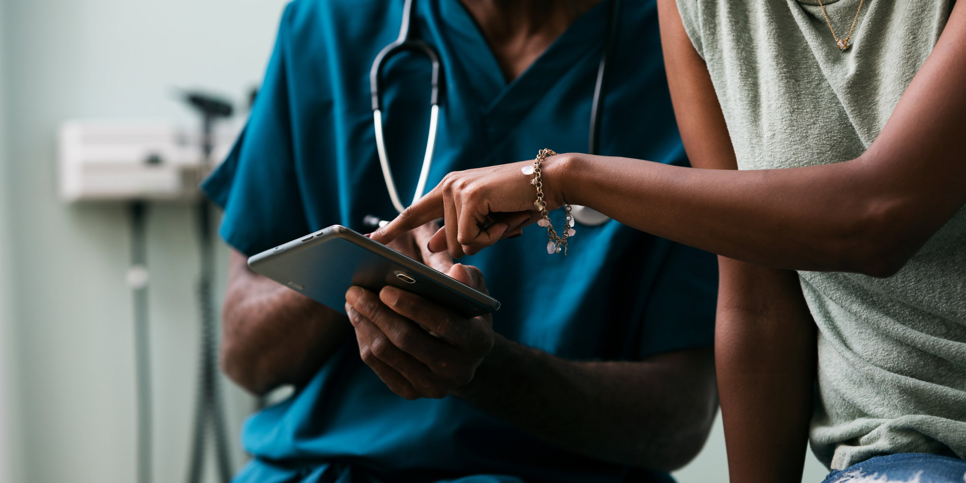 Doctor shows patient information on a digital tablet