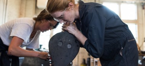 Students using a bellow in the foundry