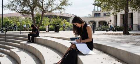 Student studying on stone steps in engineering quad