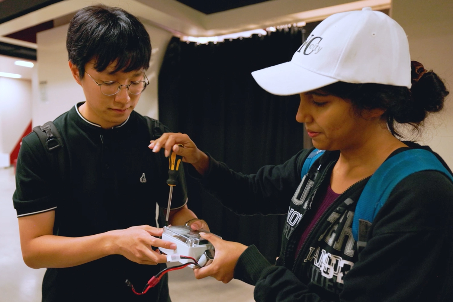 Two students assembling a sensor box.
