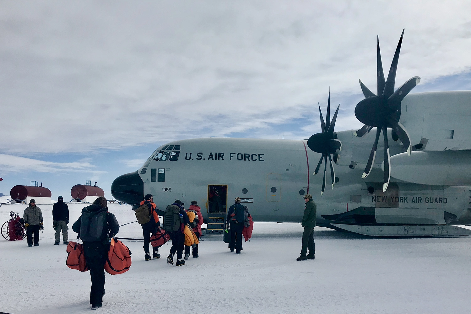 Passengers boarding Air Force plane on ice.