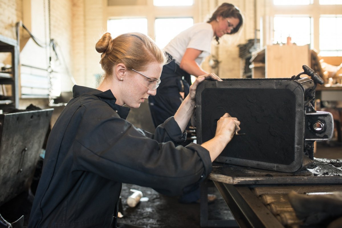 Two students create a bronze cast of the Stanford seal at the Product Realization Lab